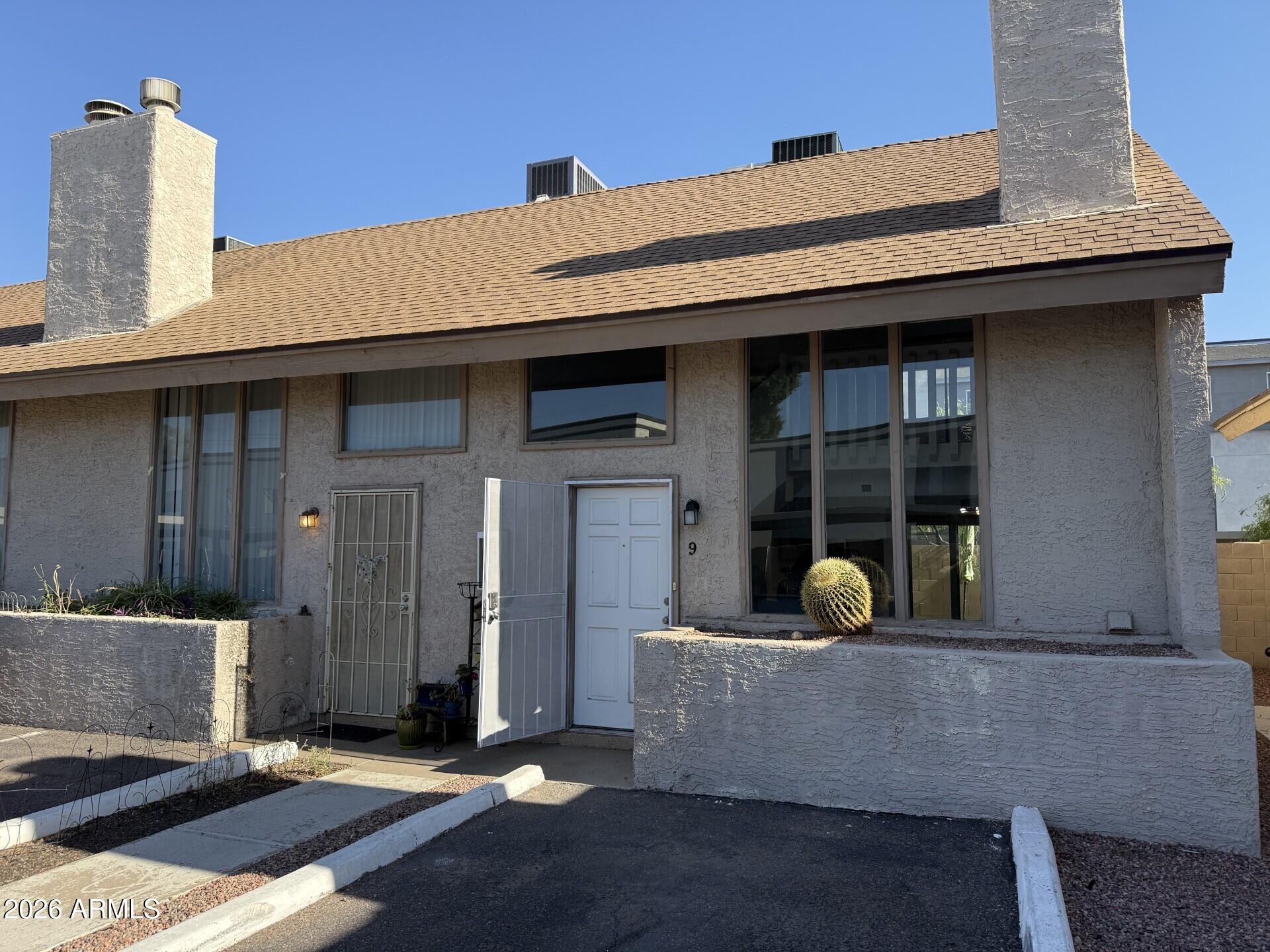 4240 North Longview Avenue, Unit 9 Phoenix, AZ 85014 - Photo 1 of 13 a front view of a house with glass windows
