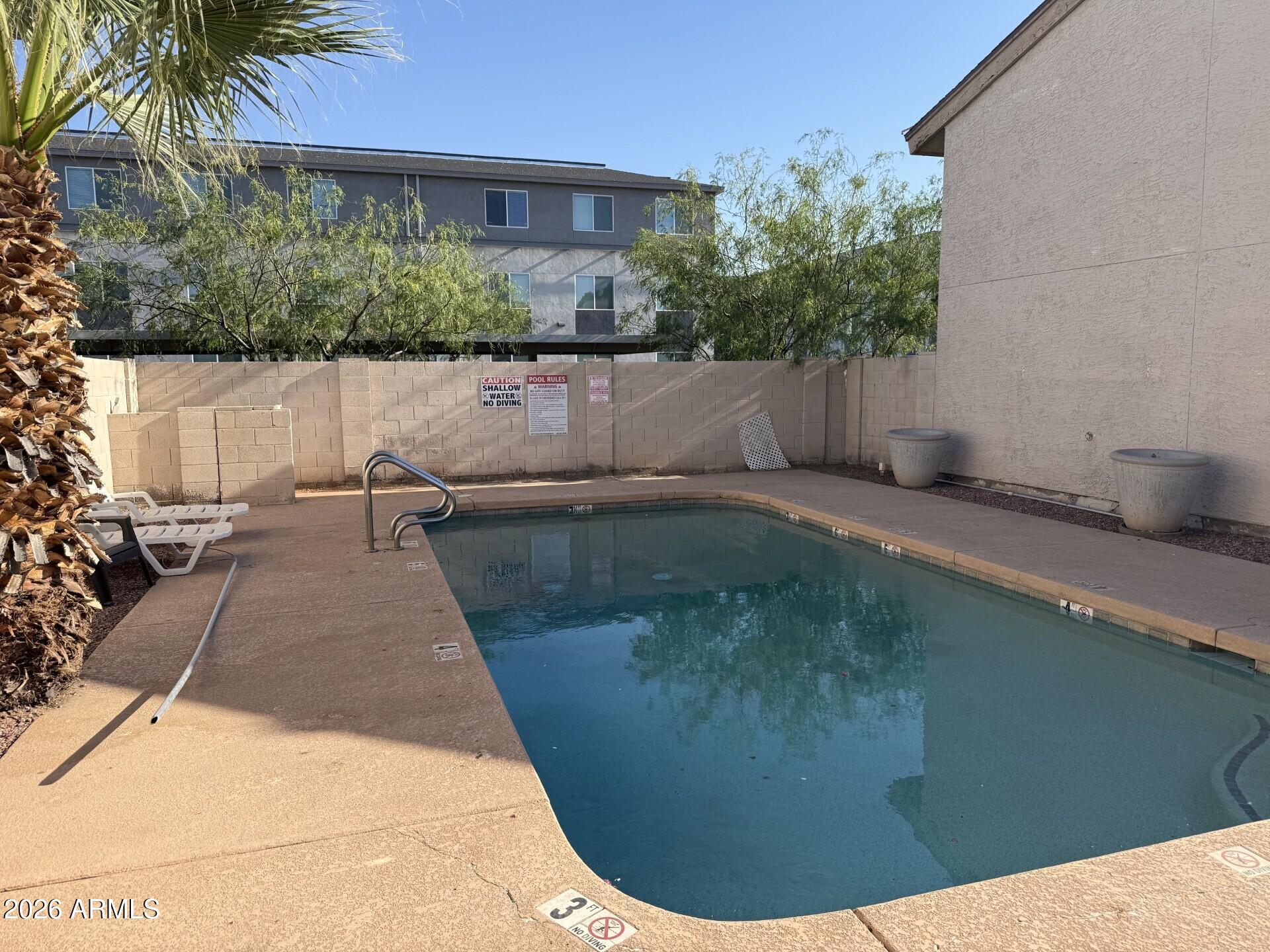 4240 North Longview Avenue, Unit 9 Phoenix, AZ 85014 - Photo 13 of 13 a view of a swimming pool with a patio