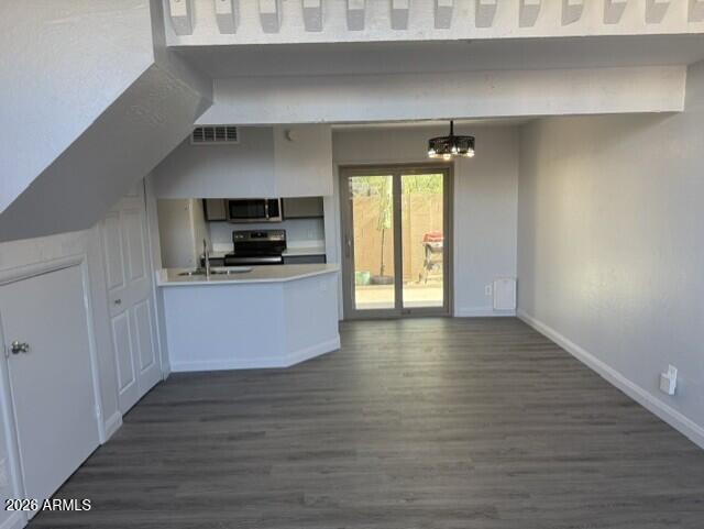 4240 North Longview Avenue, Unit 9 Phoenix, AZ 85014 - Photo 3 of 13 a kitchen with granite countertop a stove and a wooden floor