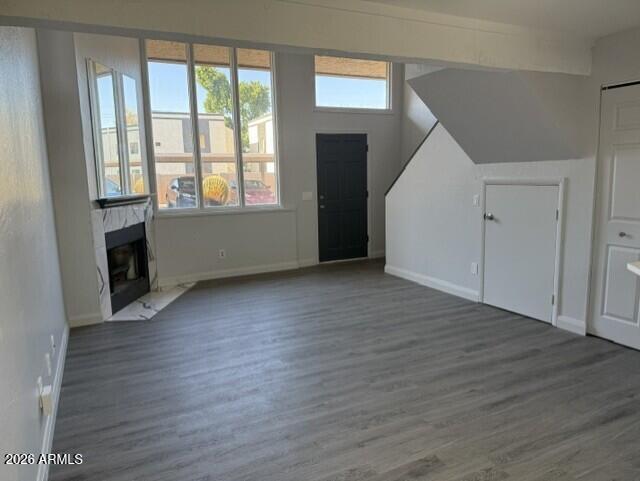 4240 North Longview Avenue, Unit 9 Phoenix, AZ 85014 - Photo 4 of 13 an empty room with wooden floor and windows