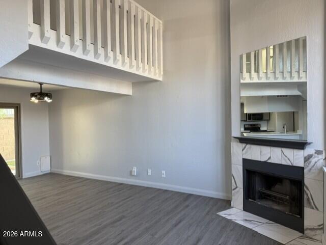 4240 North Longview Avenue, Unit 9 Phoenix, AZ 85014 - Photo 5 of 13 a view of an empty room with wooden floor fireplace and a window