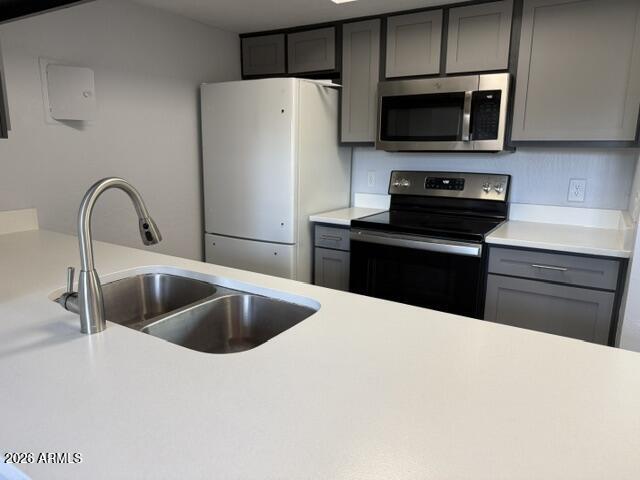 4240 North Longview Avenue, Unit 9 Phoenix, AZ 85014 - Photo 7 of 13 a kitchen with stainless steel appliances kitchen island a refrigerator sink and microwave