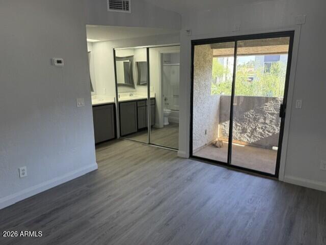 4240 North Longview Avenue, Unit 9 Phoenix, AZ 85014 - Photo 8 of 13 a view of an empty room with glass door and a window