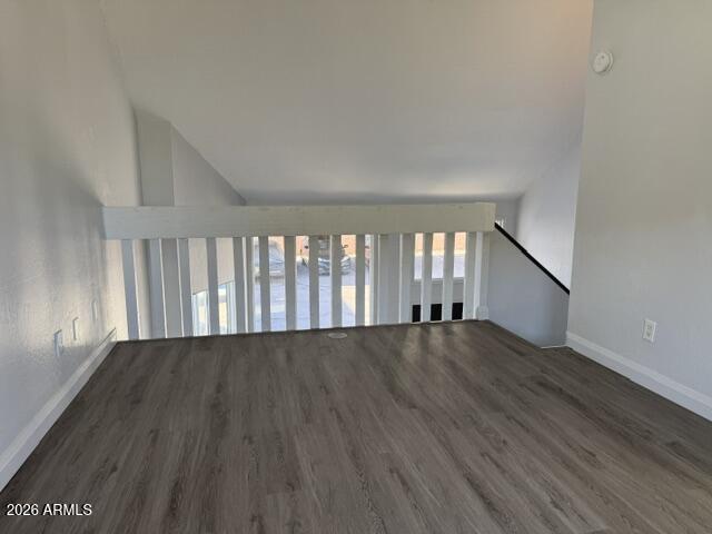 4240 North Longview Avenue, Unit 9 Phoenix, AZ 85014 - Photo 9 of 13 an empty room with wooden floor and windows