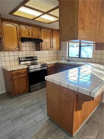 a kitchen with stainless steel appliances granite countertop a sink and a stove