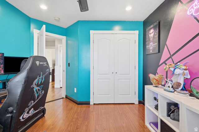 860 West 2980th Street South Logan, UT 84321 - Photo 24 of 38 Room featuring wood-finish flooring, two-panel bifold closet doors, a recessed ceiling light, a ceiling fan, and painted walls