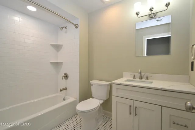 a bathroom with a sink toilet a mirror and shower