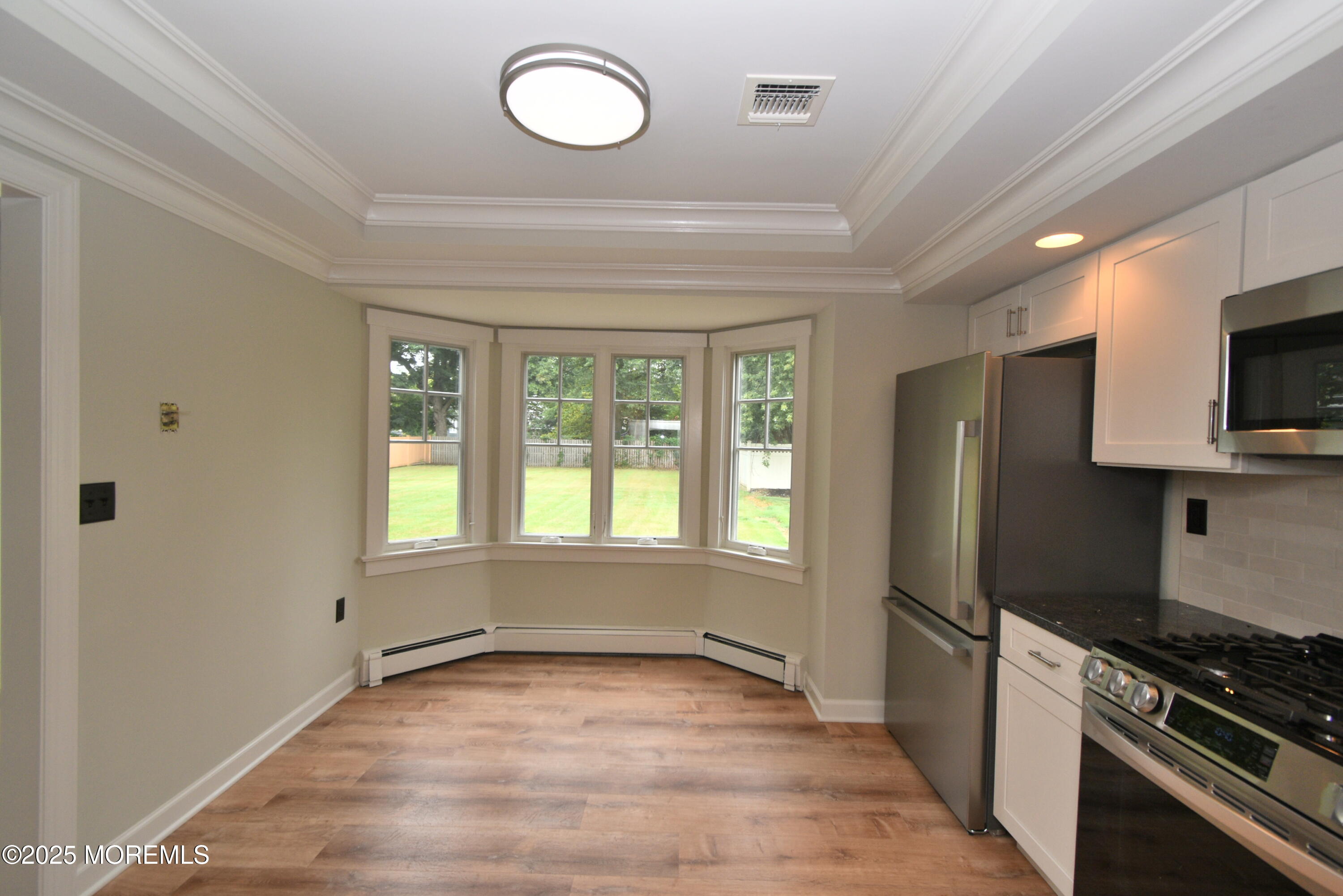 324 A Broad Street Keyport, NJ 07735 - Photo 3 of 19 a kitchen with granite countertop a refrigerator stove and microwave
