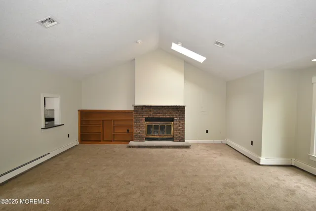 a view of empty room with a fireplace