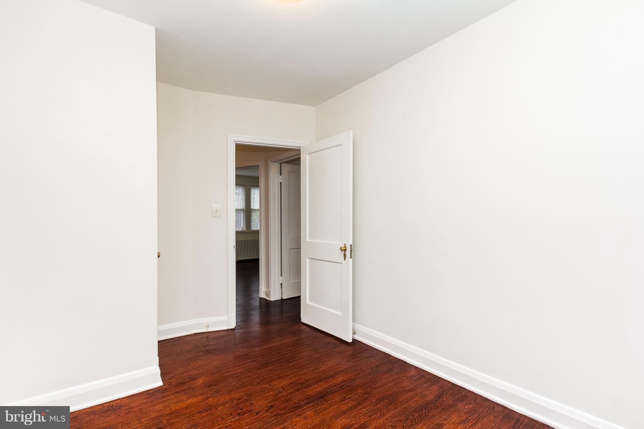 5228 Old Frederick Road Baltimore, MD 21229 - Photo 14 of 28 a view of an empty room with wooden floor and closet