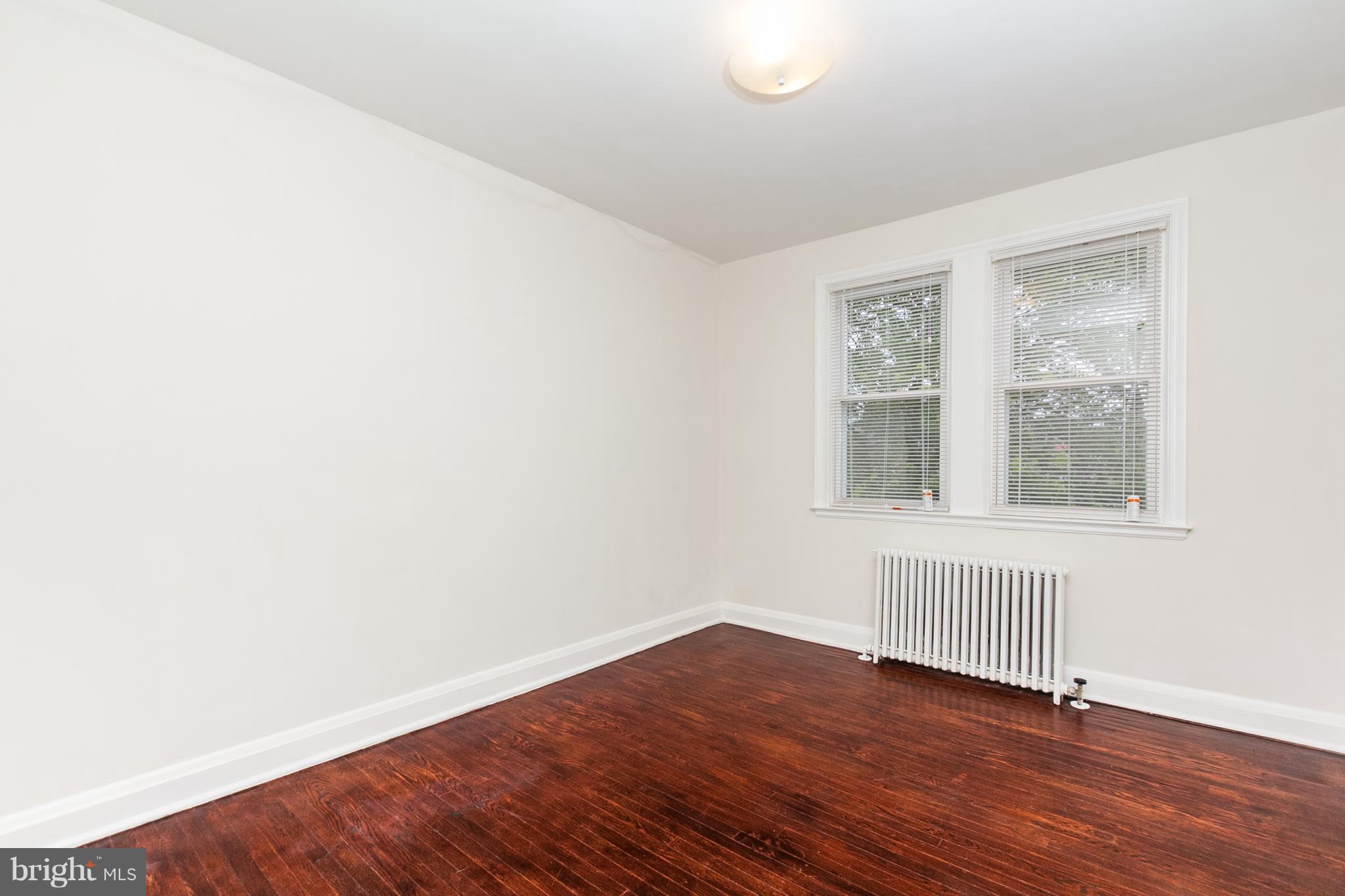 5228 Old Frederick Road Baltimore, MD 21229 - Photo 15 of 28 a view of an empty room with wooden floor and a window