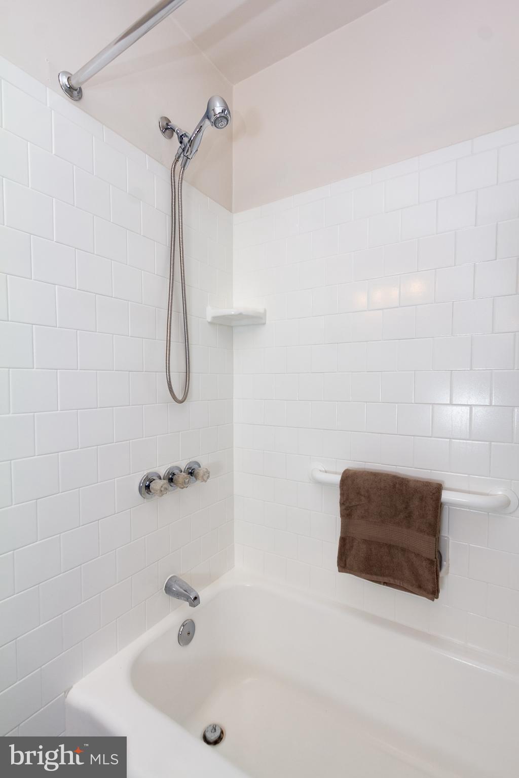 5228 Old Frederick Road Baltimore, MD 21229 - Photo 19 of 28 a bathroom with a bath tub with a shower
