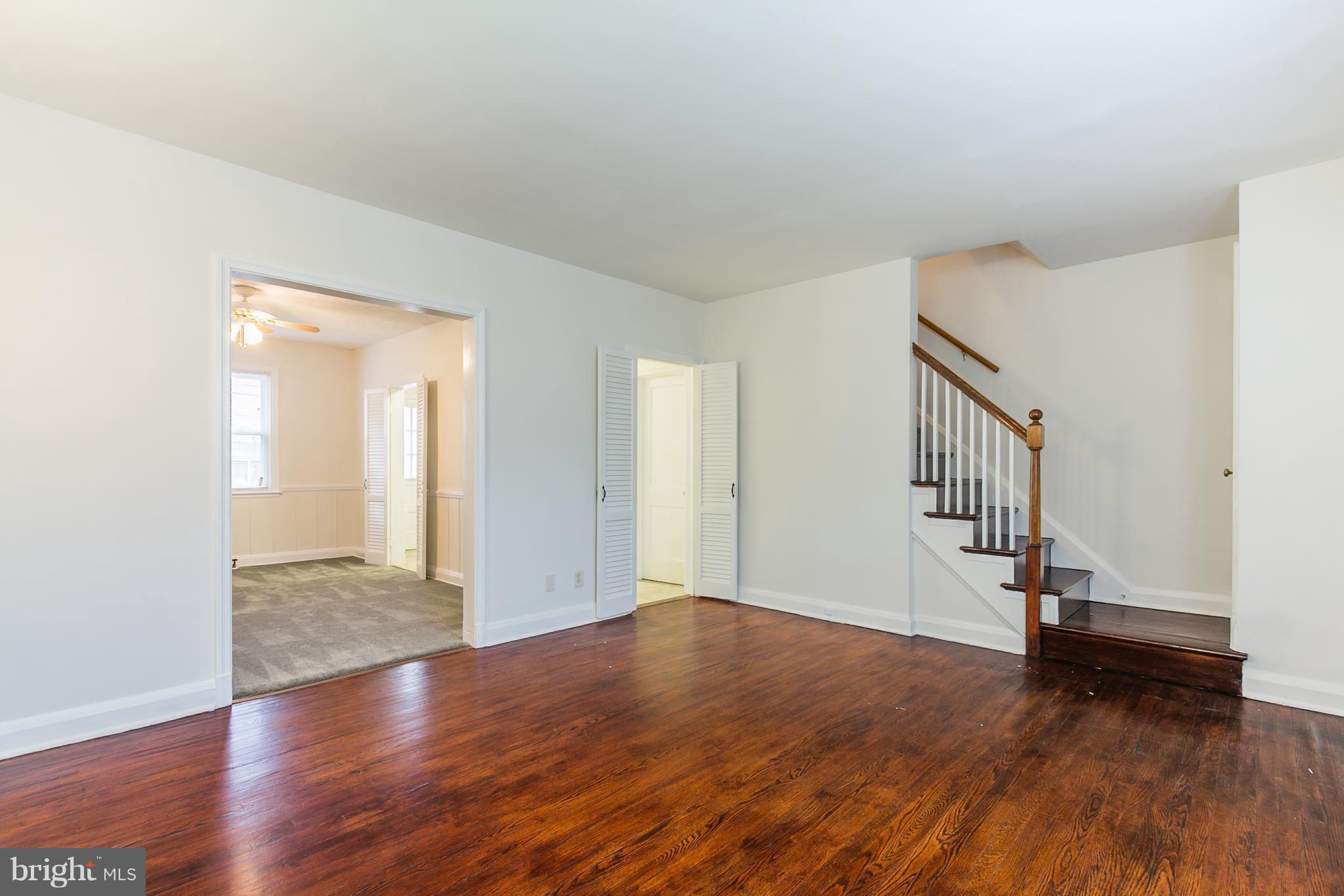 5228 Old Frederick Road Baltimore, MD 21229 - Photo 3 of 28 a view of an empty room with wooden floor and stairs