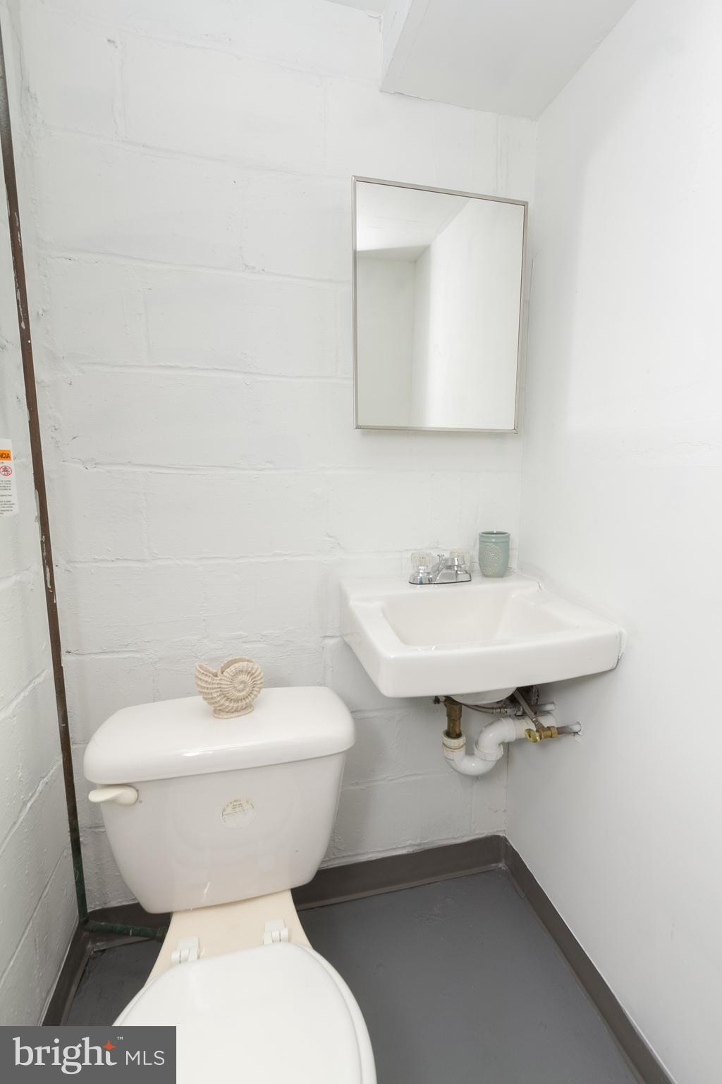5228 Old Frederick Road Baltimore, MD 21229 - Photo 24 of 28 a bathroom with a sink toilet and a mirror