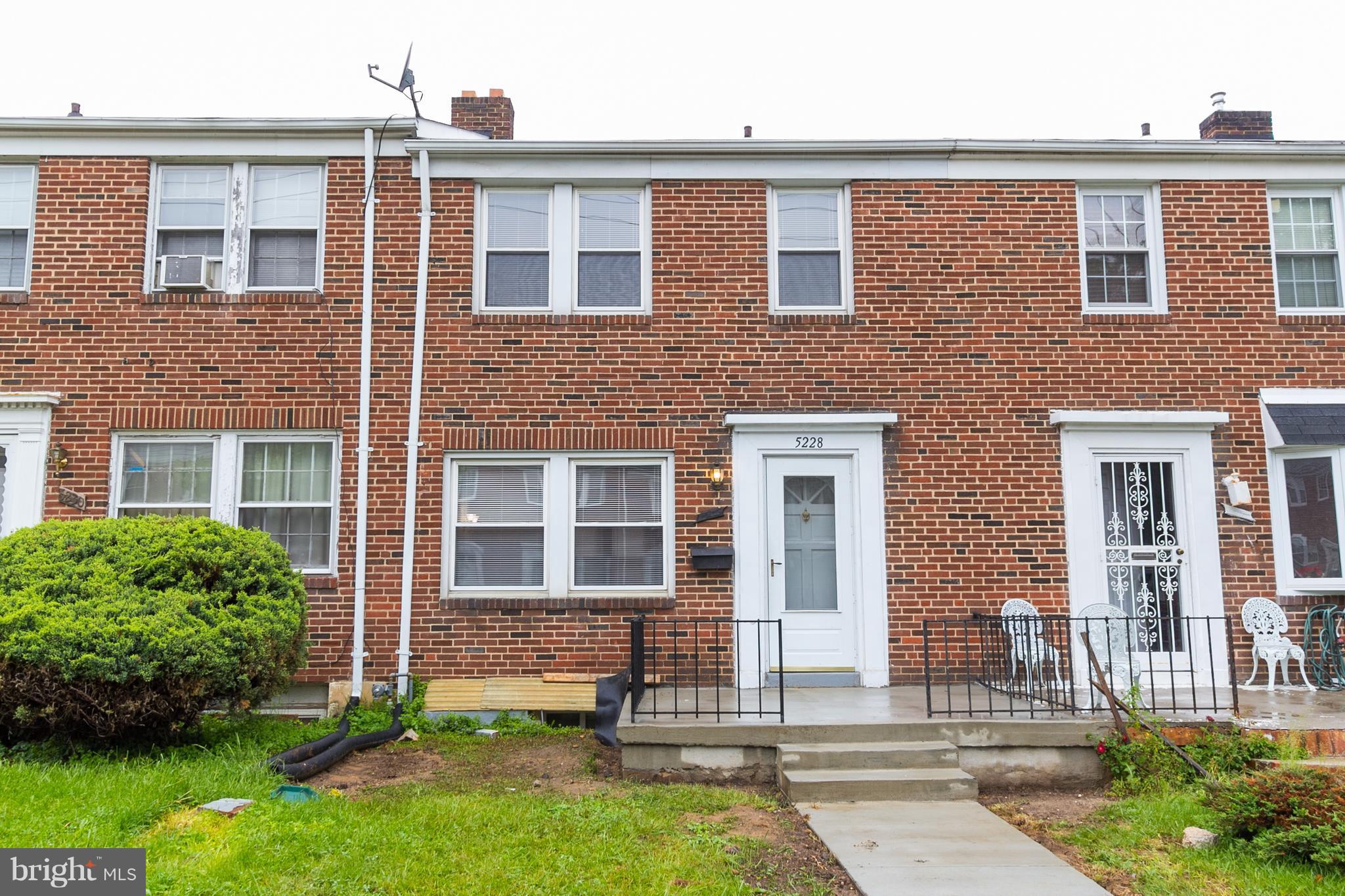 5228 Old Frederick Road Baltimore, MD 21229 - Photo 28 of 28 a front view of a brick house with a yard