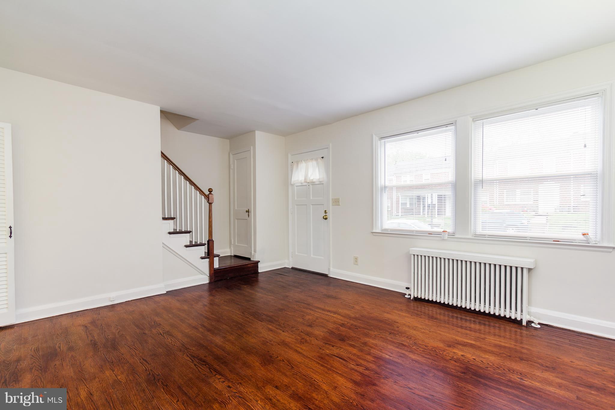 5228 Old Frederick Road Baltimore, MD 21229 - Photo 4 of 28 an empty room with wooden floor and windows