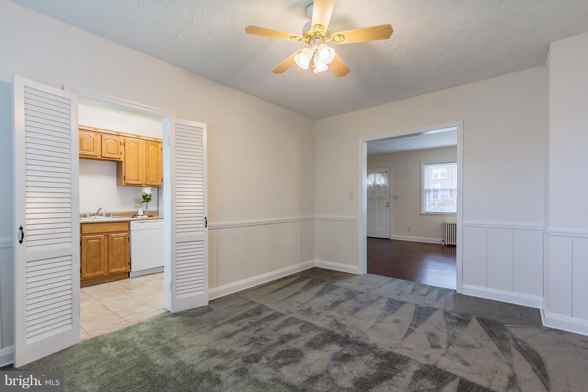 5228 Old Frederick Road Baltimore, MD 21229 - Photo 7 of 28 a view of a livingroom with wooden floor and a ceiling fan