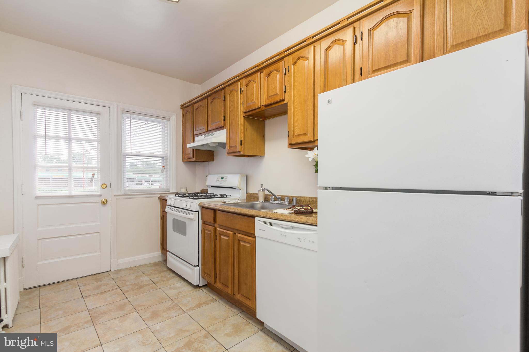 5228 Old Frederick Road Baltimore, MD 21229 - Photo 9 of 28 a kitchen with stainless steel appliances granite countertop a sink and a stove top oven