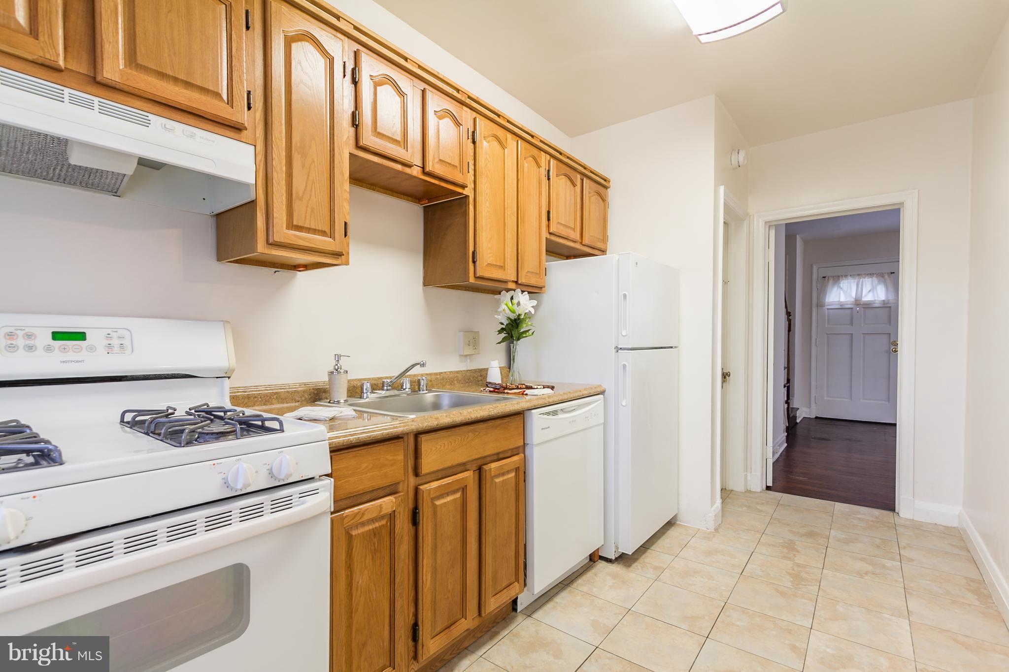 5228 Old Frederick Road Baltimore, MD 21229 - Photo 10 of 28 a kitchen with stainless steel appliances granite countertop a stove and a refrigerator