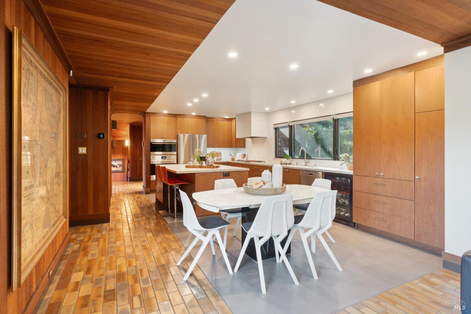 14 Oak Grove Way Napa, CA 94559 - Photo 19 of 56 a dining room with stainless steel appliances a dining table wooden floor and a kitchen view