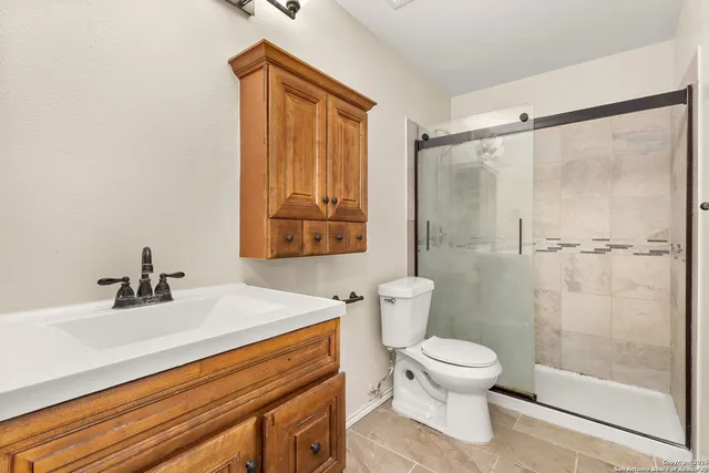 a bathroom with a sink toilet and shower
