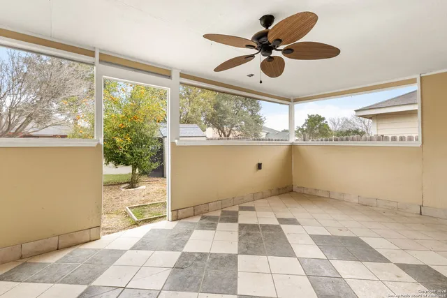 a very nice looking room with a large window cabinets and stainless steel appliances