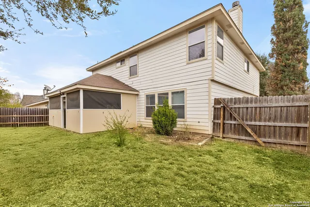 a view of house with backyard