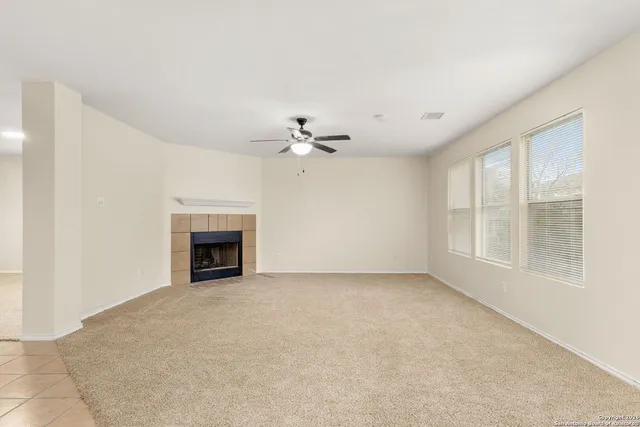 a view of an empty room with a fireplace