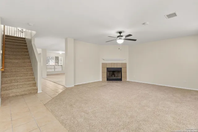 en view of an empty room with a fireplace