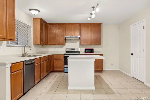 a kitchen with cabinets and window