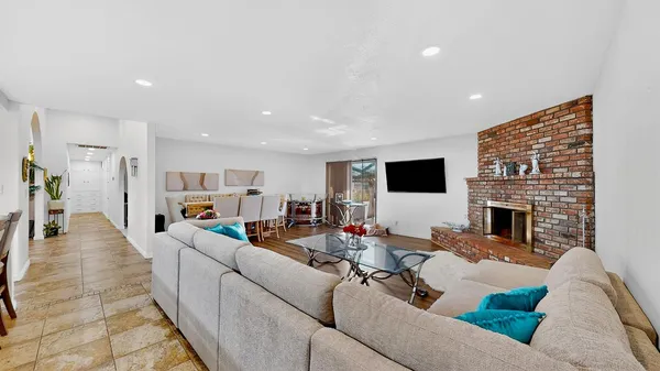 a living room with fireplace furniture and a flat screen tv