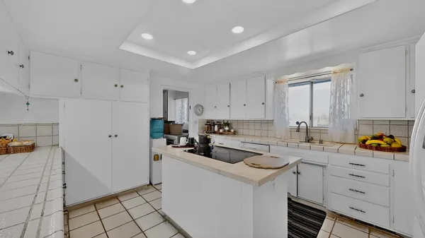 a kitchen with a sink a stove cabinets and counter space