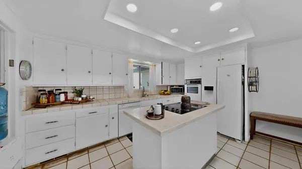 a kitchen with refrigerator and cabinets