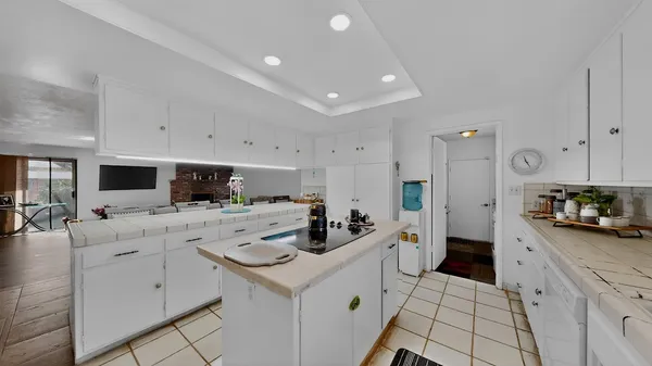 a kitchen with counter top space appliances and cabinets