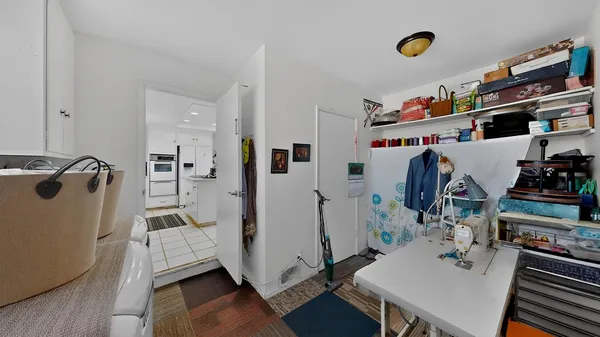 a view of a workspace with furniture and wooden floor