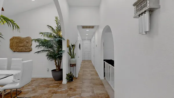 a view of a hallway with potted plants