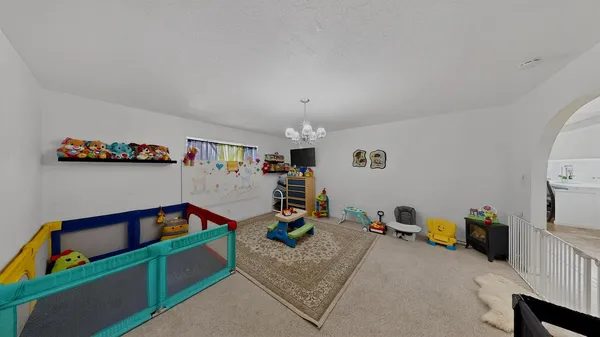 a bedroom with furniture and a lamp