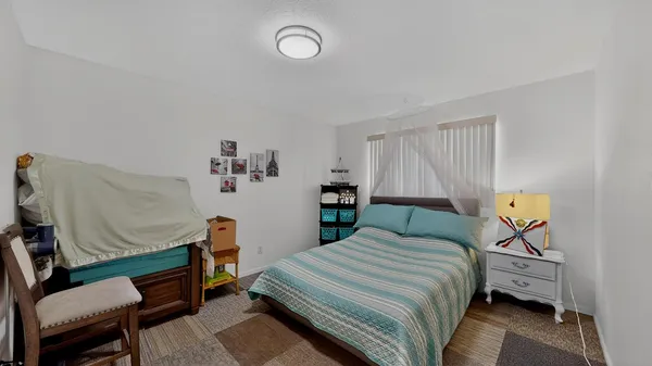 a bedroom with a bed a couch and dresser