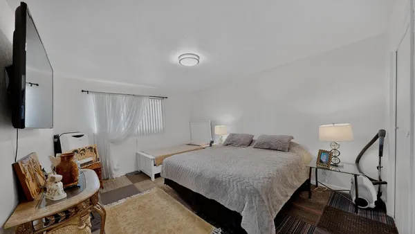 a bedroom with a bed and a couch