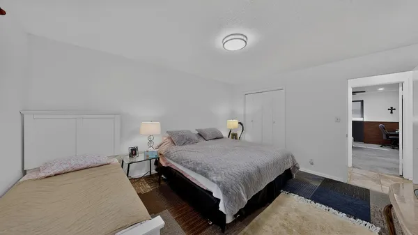 a bedroom with a bed and a flat screen tv