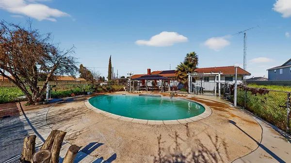 an aerial view of a house with a swimming pool yard and outdoor seating