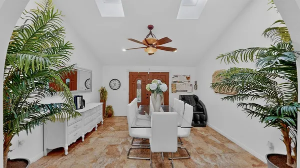 a living room with furniture a potted plant and a rug