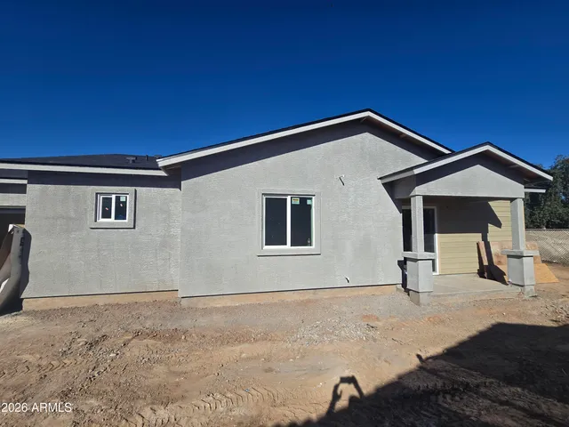 a view of a house with a backyard
