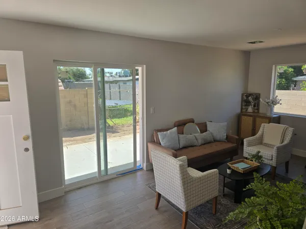 a living room with furniture and a floor to ceiling window