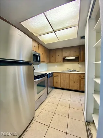 a kitchen with stainless steel appliances granite countertop a refrigerator sink and cabinets