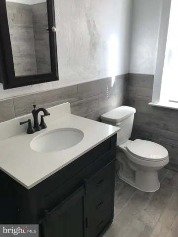 a bathroom with a sink toilet and mirror