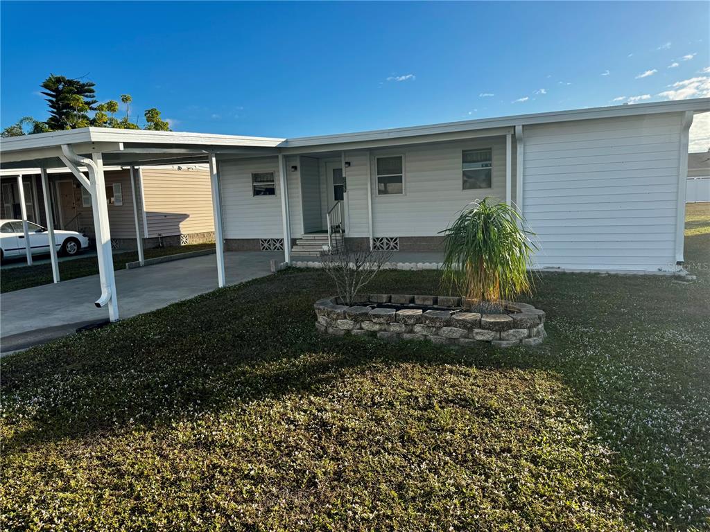 5619 Bayshore Road, Unit 203 Palmetto, FL 34221 - Photo 1 of 1 a front view of a house with a yard