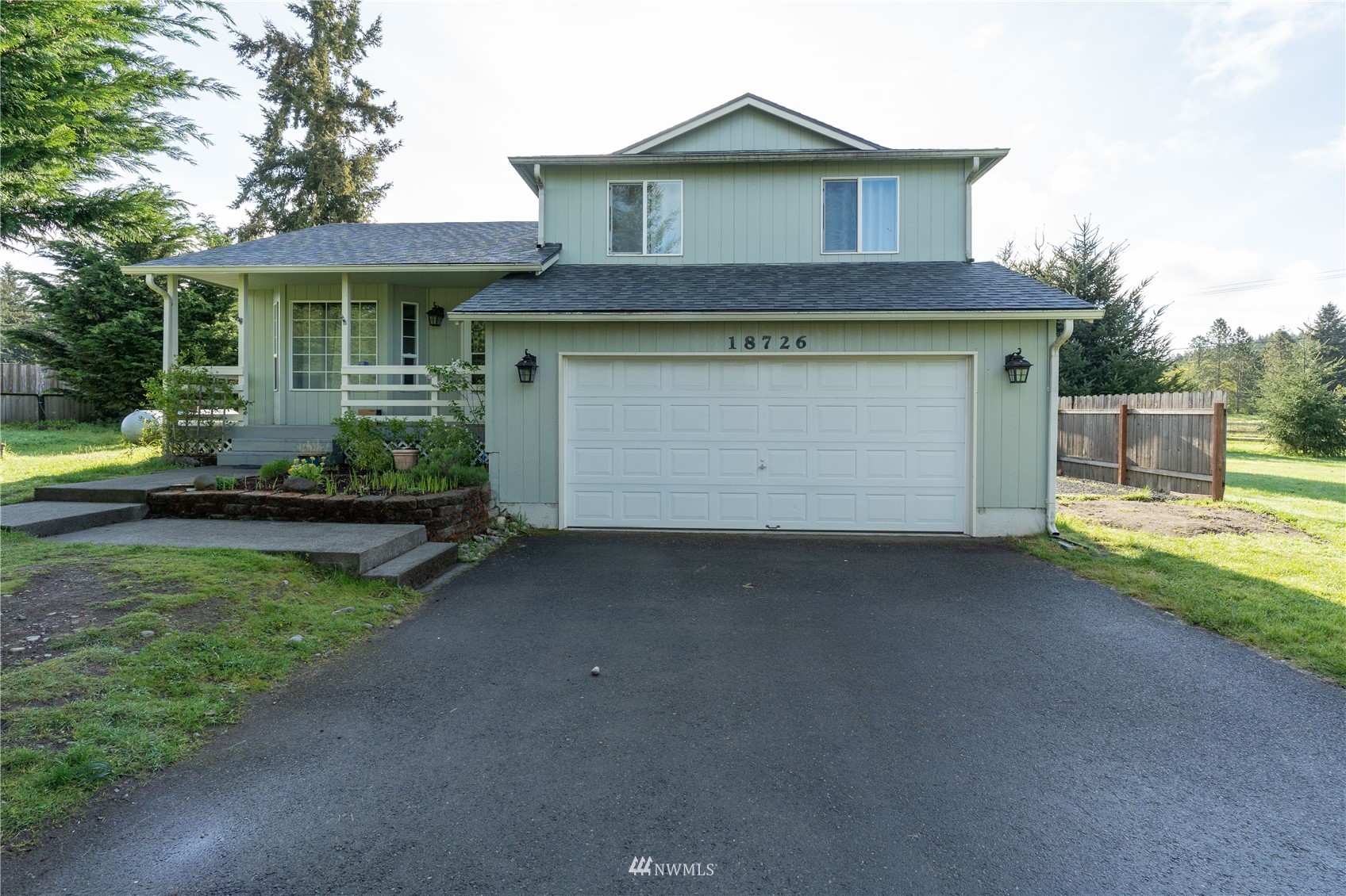 18726 Deerfield Lane Southwest Rochester, WA 98579 - Photo 1 of 27 a front view of a house with a yard and garage