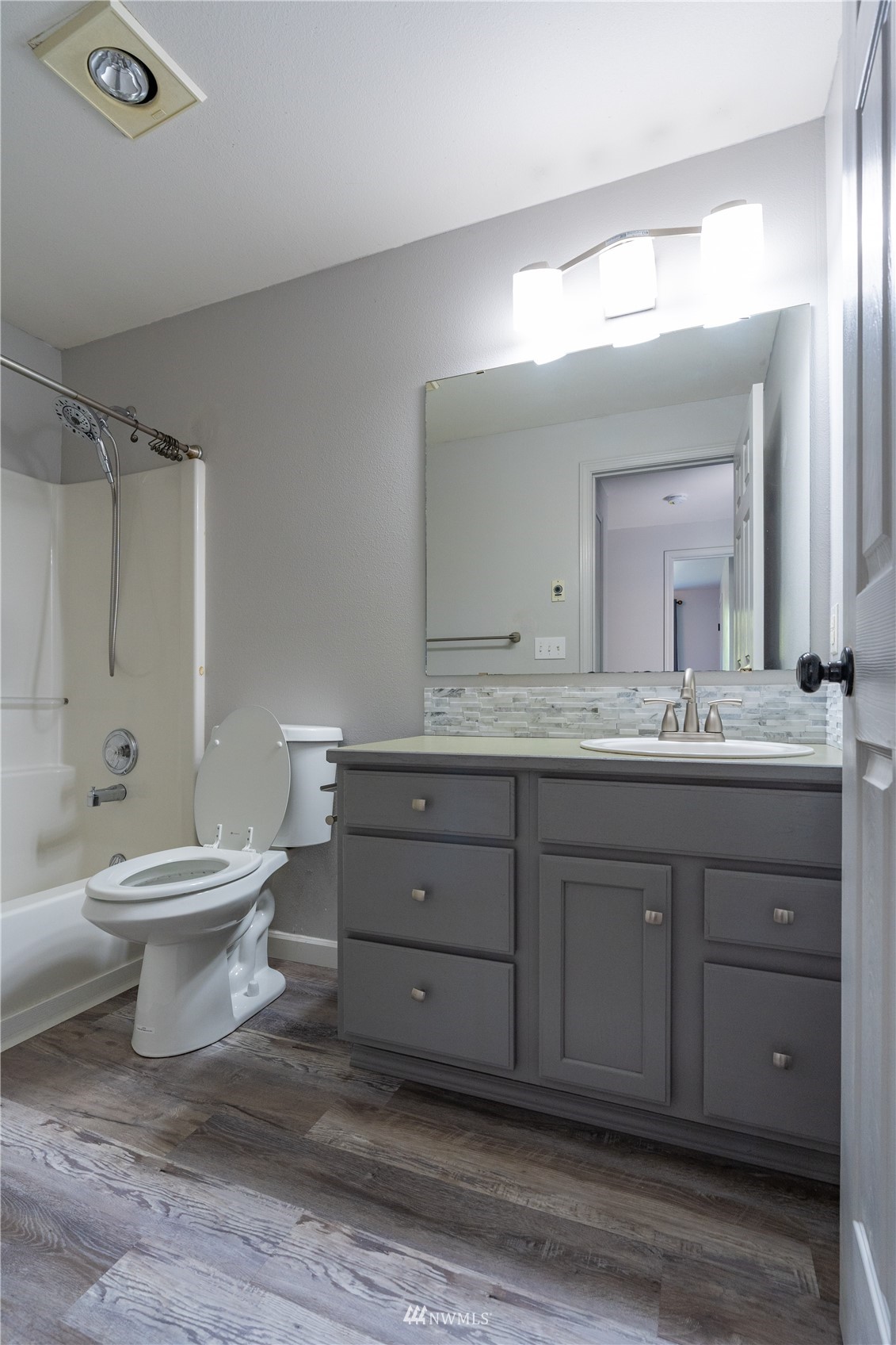 18726 Deerfield Lane Southwest Rochester, WA 98579 - Photo 21 of 27 a bathroom with a double vanity sink a toilet and a mirror