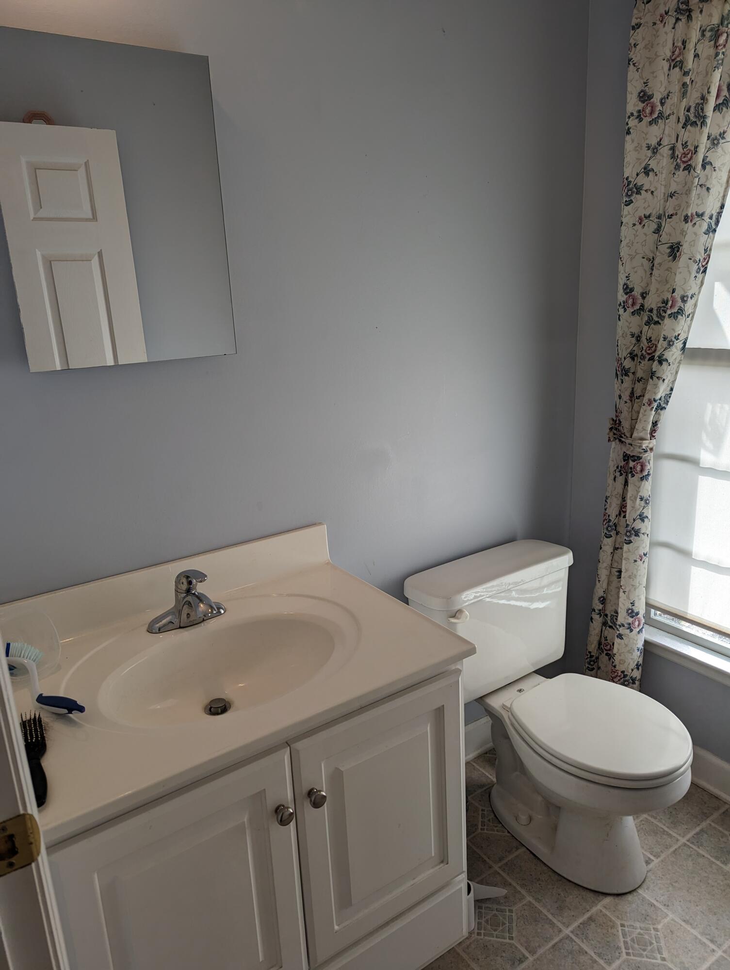 4715 Providence Church Road Ferrum, VA 24088 - Photo 15 of 46 a white toilet sitting next to a bathroom sink